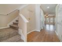Carpeted staircase and wood flooring in the hallway at 2226 Seven Oaks Dr, St Cloud, FL 34772
