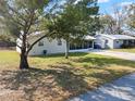 Well-kept home with a metal roof, manicured lawn, and a screened porch at 2601 16Th St, St Cloud, FL 34769