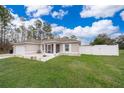 House exterior with a screened porch and grassy lawn at 3 Pecan Drive Loop, Ocala, FL 34472