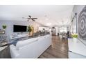 Open living area with gray sofa, hardwood floors, and kitchen view at 3 Pecan Drive Loop, Ocala, FL 34472