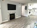 Bright living room featuring a fireplace, tile flooring, and open kitchen layout at 345 Forestway Cir # 106, Altamonte Springs, FL 32701