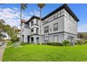 Condo building with gray and white exterior, and lush green lawn at 3701 Castle Pines Ln # 3927, Orlando, FL 32839