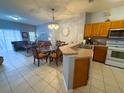 Open-concept kitchen and dining area featuring modern appliances, tiled floors, and a seamless flow to the living space at 4557 Ada Ln, Kissimmee, FL 34746