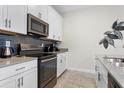 Modern kitchen with white cabinets, stainless steel appliances at 4818 Memories Ln, Kissimmee, FL 34746