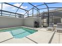 Small private screened pool with lounge chairs and grill at 4818 Memories Ln, Kissimmee, FL 34746