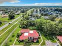 Aerial view of a red-roofed townhouse nestled in a wooded area at 540 Hunter Cir, Kissimmee, FL 34758
