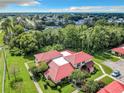 Aerial view of a townhouse with red tile roof and lush landscaping at 540 Hunter Cir, Kissimmee, FL 34758