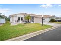 Front view of a single-story house with a paved driveway at 580 Teesdale, Haines City, FL 33844