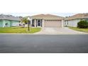 Single-story home with attached garage and landscaped yard at 580 Teesdale, Haines City, FL 33844