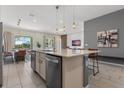 Modern kitchen with large island, stainless steel appliances, and breakfast bar at 6052 Broad Oak Dr, Davenport, FL 33837