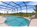 Inviting screened pool and spa with lounge chairs at 6052 Broad Oak Dr, Davenport, FL 33837