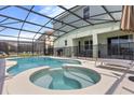 Relaxing screened pool and spa with patio furniture at 6052 Broad Oak Dr, Davenport, FL 33837