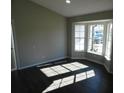 Spacious living room with bay window, dark laminate floors, and recessed lighting at 1972 S Old Mill Dr, Deltona, FL 32725