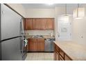 Updated kitchen featuring wood cabinets, granite counters & stainless steel appliances at 12538 Floridays Resort Dr # 411, Orlando, FL 32821