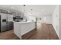 Modern kitchen with gray cabinets, quartz countertops, and stainless steel appliances at 13380 Sw 60Th Court Rd, Ocala, FL 34473