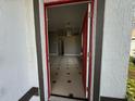 Inviting entryway with tile flooring, a red-framed door, and a view into the spacious living area at 143 Glasgow Ct, Davenport, FL 33897