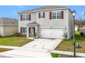 Two-story house with attached garage and red shutters at 1634 Reddish Egret Ct, Davenport, FL 33897