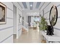 Bright entryway with high ceilings, striped walls, and view to the dining area at 2190 Lelani Cir, Davenport, FL 33897