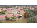 Community overview, showcasing homes with red tile roofs at 3033 Sangria St, Kissimmee, FL 34744
