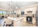 Bright kitchen features granite countertops, stainless steel appliances, and a center island at 605 Cantabria Dr, Davenport, FL 33837
