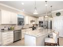 Stylish kitchen boasts stainless steel appliances, granite counters, and a breakfast bar at 605 Cantabria Dr, Davenport, FL 33837