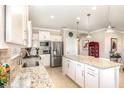Open kitchen with stainless steel appliances, large island, and a breakfast bar at 605 Cantabria Dr, Davenport, FL 33837