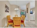 Bright dining room with wicker chairs and glass-top table at 801 New Providence # B19/U801, Davenport, FL 33897