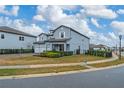 Side view of two-story house with a landscaped yard at 8024 Leaf Grove Cir, Orlando, FL 32836