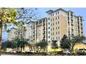 A multi-story condo complex displays balconies and green shutters in this daytime exterior view at 8100 Poinciana Blvd # 2405, Orlando, FL 32821