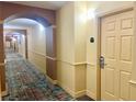Well-maintained hallway leads to apartments within a building with secure key-card access at 8100 Poinciana Blvd # 2405, Orlando, FL 32821