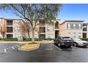 Exterior parking lot with two cars parked and a tree at 8277 Maritime Flag St # 204, Windermere, FL 34786