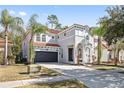 Two-story house with gray exterior, tile roof, and a two-car garage at 901 Marcello Blvd, Kissimmee, FL 34746