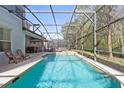 Inviting screened-in pool with a spa and plenty of space for relaxation at 901 Marcello Blvd, Kissimmee, FL 34746