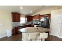 Kitchen with granite island, wood cabinets, and stainless steel appliances at 1015 Sabine Pl, Kissimmee, FL 34759