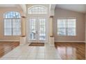 Bright entryway with double doors, tile floors, and hardwood floors at 10398 Stone Glen Dr, Orlando, FL 32825