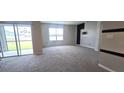 Spacious living room with large window and neutral carpet at 1057 Cambridge Dr, Winter Haven, FL 33881