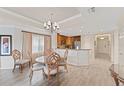 Inviting dining area with stylish chandelier and a view of the kitchen at 1108 Sunset View Cir # 204, Reunion, FL 34747