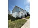 Inviting two-story townhome with blue and white siding, a well-manicured lawn, and easy access to the sidewalk at 1158 Sand Torch, Davenport, FL 33837