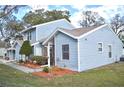 Charming blue home featuring well manicured landscaping and an inviting entrance at 118 Hidden Arbor Ct, Sanford, FL 32773