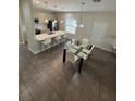 Modern kitchen with island, white countertops, and stainless steel appliances at 122 Macaulays Cv, Haines City, FL 33844