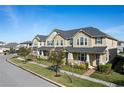 Tan townhome with gray roof, front porch, and landscaping at 2455 Varenna Loop # 1, Kissimmee, FL 34741