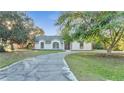 Single-story home with a curved driveway and lush landscaping at 2650 Hilliard Ct, Kissimmee, FL 34744