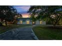 House exterior at dusk, showcasing a landscaped yard and driveway at 2650 Hilliard Ct, Kissimmee, FL 34744