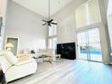 Bright living room with modern fireplace, high ceilings, and expansive sliding glass doors to the pool at 2949 Zaharias Dr, Orlando, FL 32837