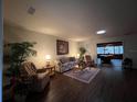 Spacious living room with hardwood floors and comfy furniture at 5030 Haywood Ruffin Rd, St Cloud, FL 34771