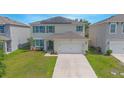 Two-story house with solar panels, driveway and green lawn at 5283 Bracks Landing Dr Dr, St Cloud, FL 34771