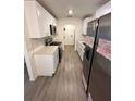 Modern kitchen with white cabinets and stainless steel appliances at 5920 Nw 65Th St, Ocala, FL 34482