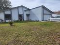 Single-story house with white exterior and gray trim at 602 Caddy Dr, Kissimmee, FL 34759