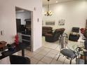 Bright, open-concept living space with tile flooring, neutral paint, and a seamless transition to the kitchen at 602 Caddy Dr, Kissimmee, FL 34759