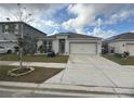 Single-story home with a two-car garage at 606 Tortugas St, Haines City, FL 33844